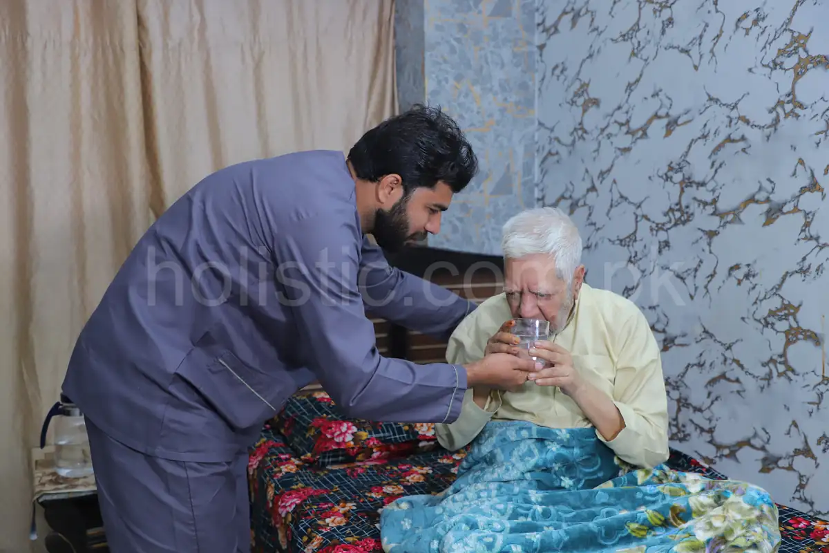 elderly care service in Pakistan with professional caregiver assisting senior patient
